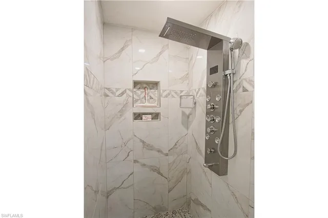 a bathroom with a shower and a sink