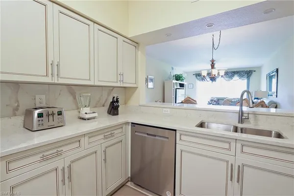 a kitchen with white cabinets and a sink
