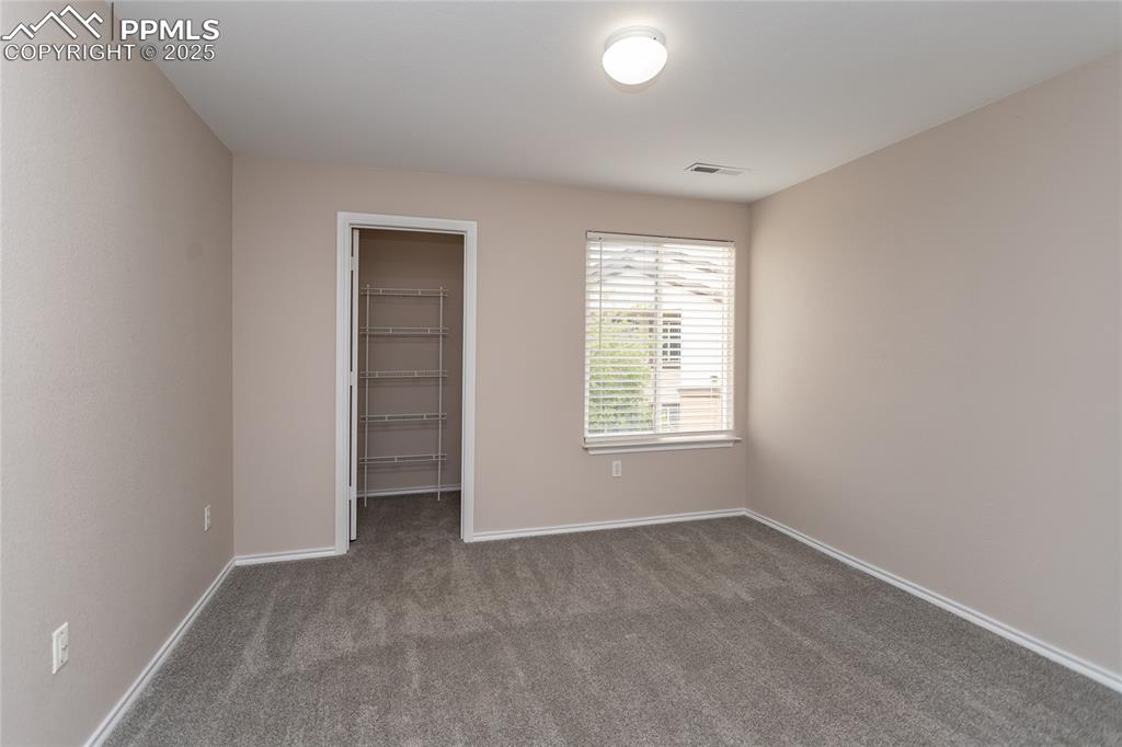 3815 Riviera Grove, Unit 201 Colorado Springs, CO 80922 - Photo 13 of 31 an empty room with windows and closet