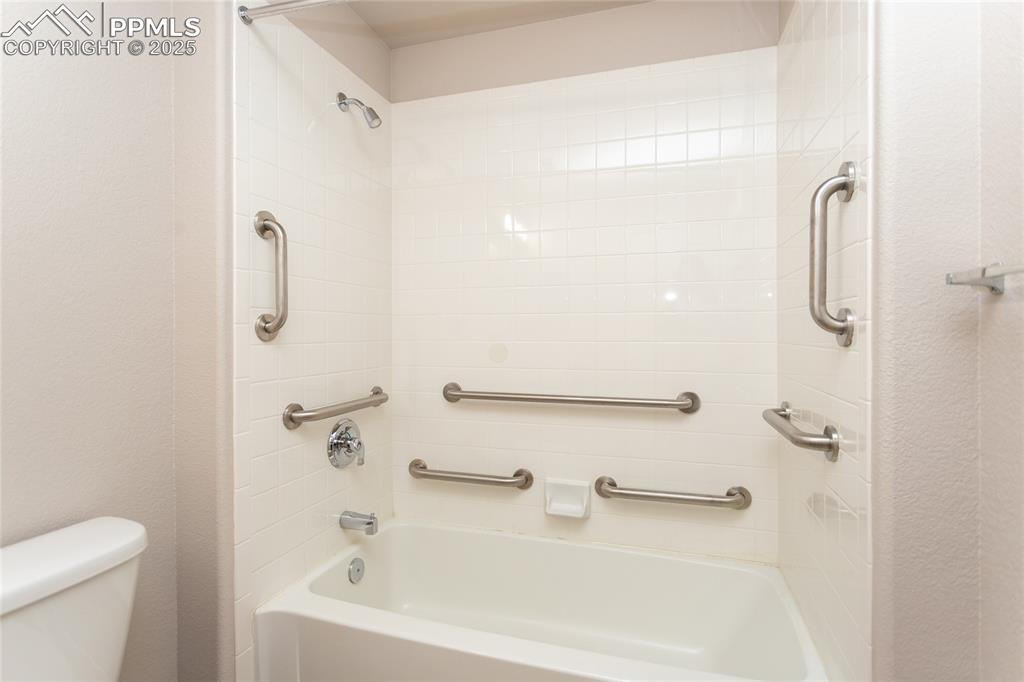 3815 Riviera Grove, Unit 201 Colorado Springs, CO 80922 - Photo 16 of 31 a bathroom with a white bath tub a shower and a toilet sink