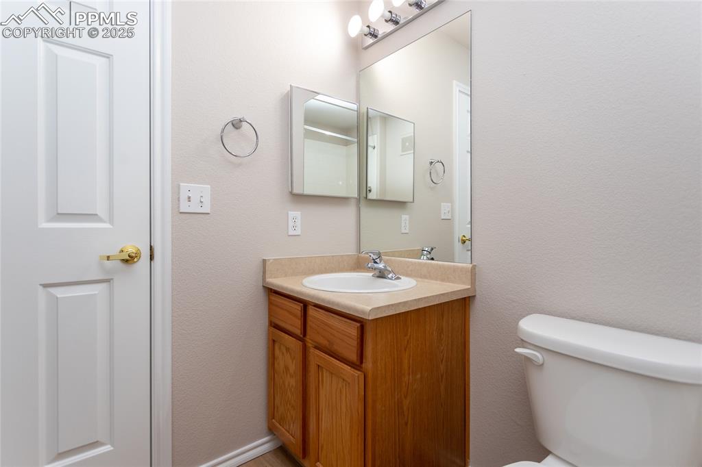 3815 Riviera Grove, Unit 201 Colorado Springs, CO 80922 - Photo 17 of 31 a bathroom with a sink toilet and mirror