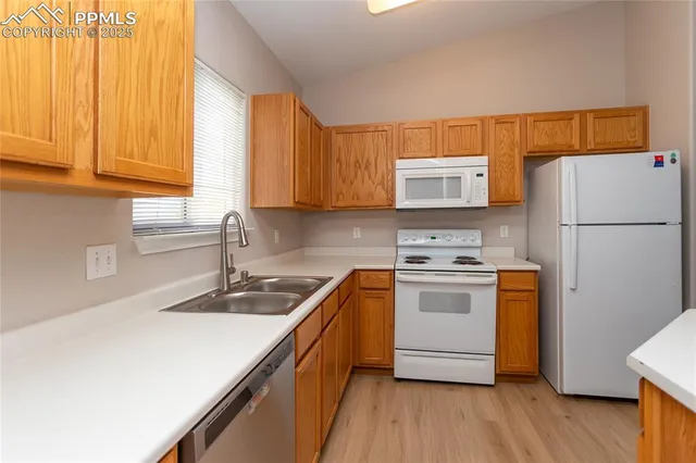 a kitchen with stainless steel appliances a stove a sink and a refrigerator