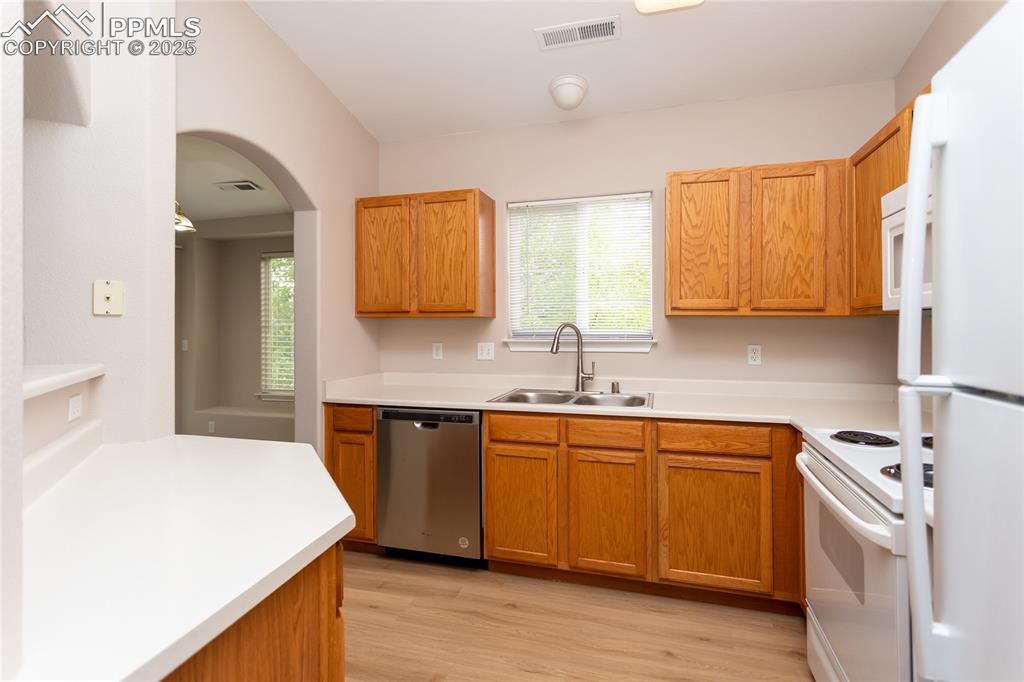 3815 Riviera Grove, Unit 201 Colorado Springs, CO 80922 - Photo 5 of 31 a kitchen with a sink cabinets and wooden floor
