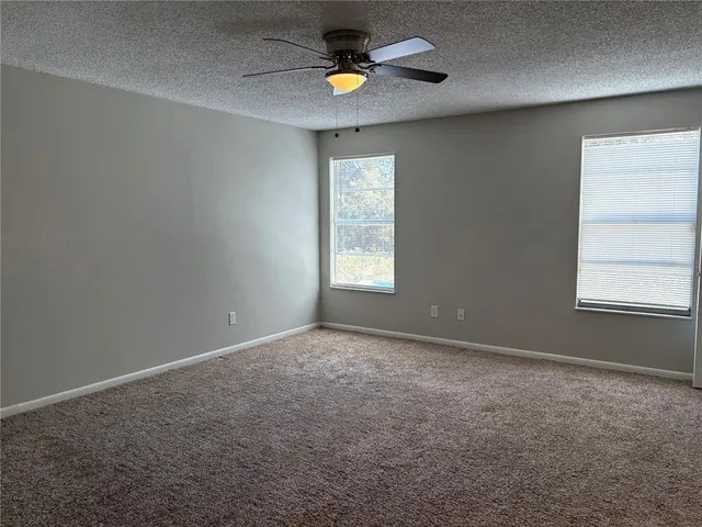 an empty room with windows and natural light