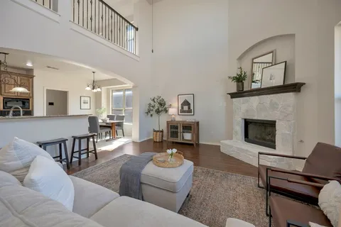 a living room with furniture a fireplace and a flat screen tv