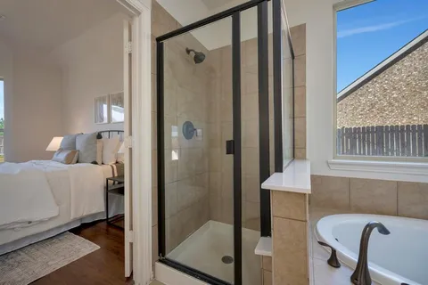 a bathroom with a shower and a sink
