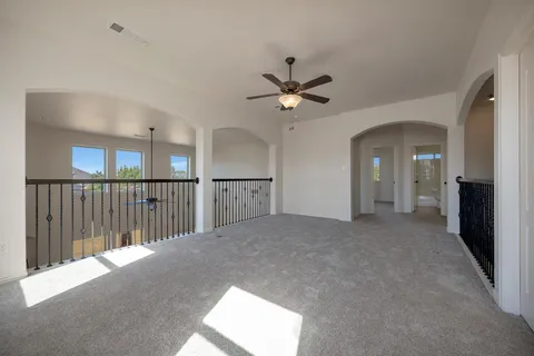 a view of a livingroom with a ceiling fan and window