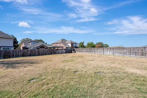 a view of a patio with table and chairs and potted plants
