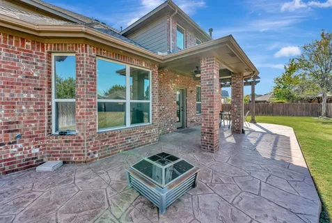 a view of a patio with a table and chairs