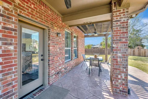 a view of a house with backyard porch and sitting area
