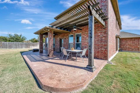 a view of a backyard with sitting area