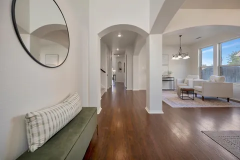 a view of a room with wooden floor and entryway