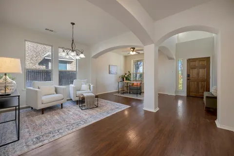 a living room with couches and painting on the wall