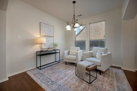 a living room with furniture a lamp and a chandelier