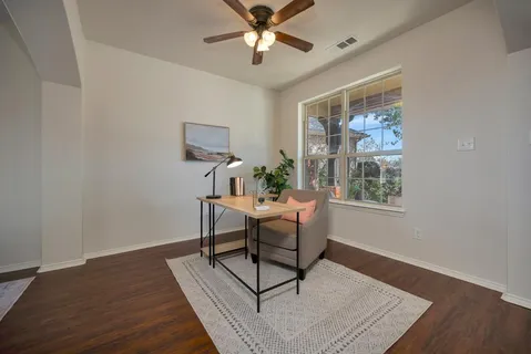 a workspace with wooden floor and a window