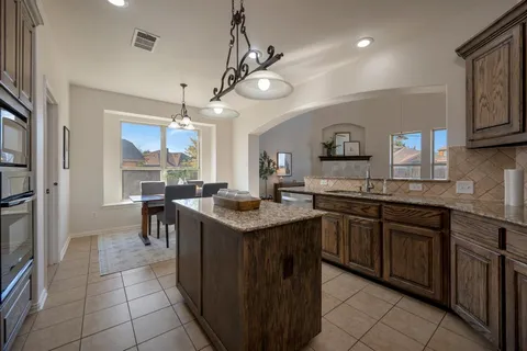 a kitchen with lots of counter top space and appliances