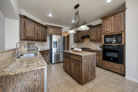 a kitchen with a stove sink and refrigerator