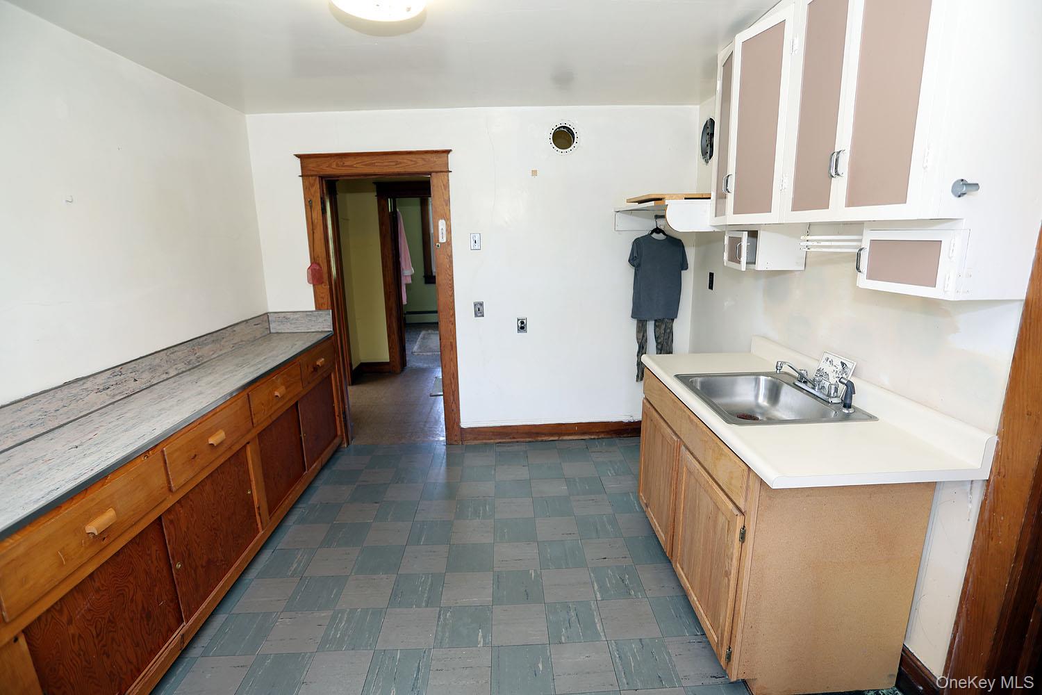 1779 Shandelee Road Livingston Manor, NY 12758 - Photo 20 of 31 a kitchen with a sink stove and cabinets