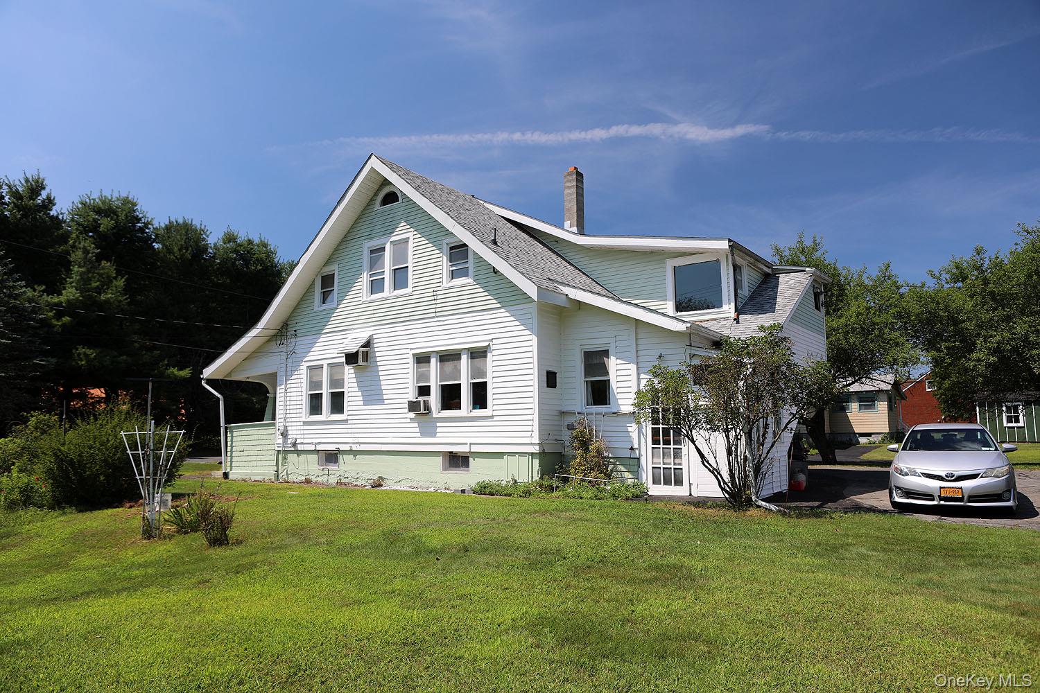 1779 Shandelee Road Livingston Manor, NY 12758 - Photo 29 of 31 a front view of a house with a garden and trees