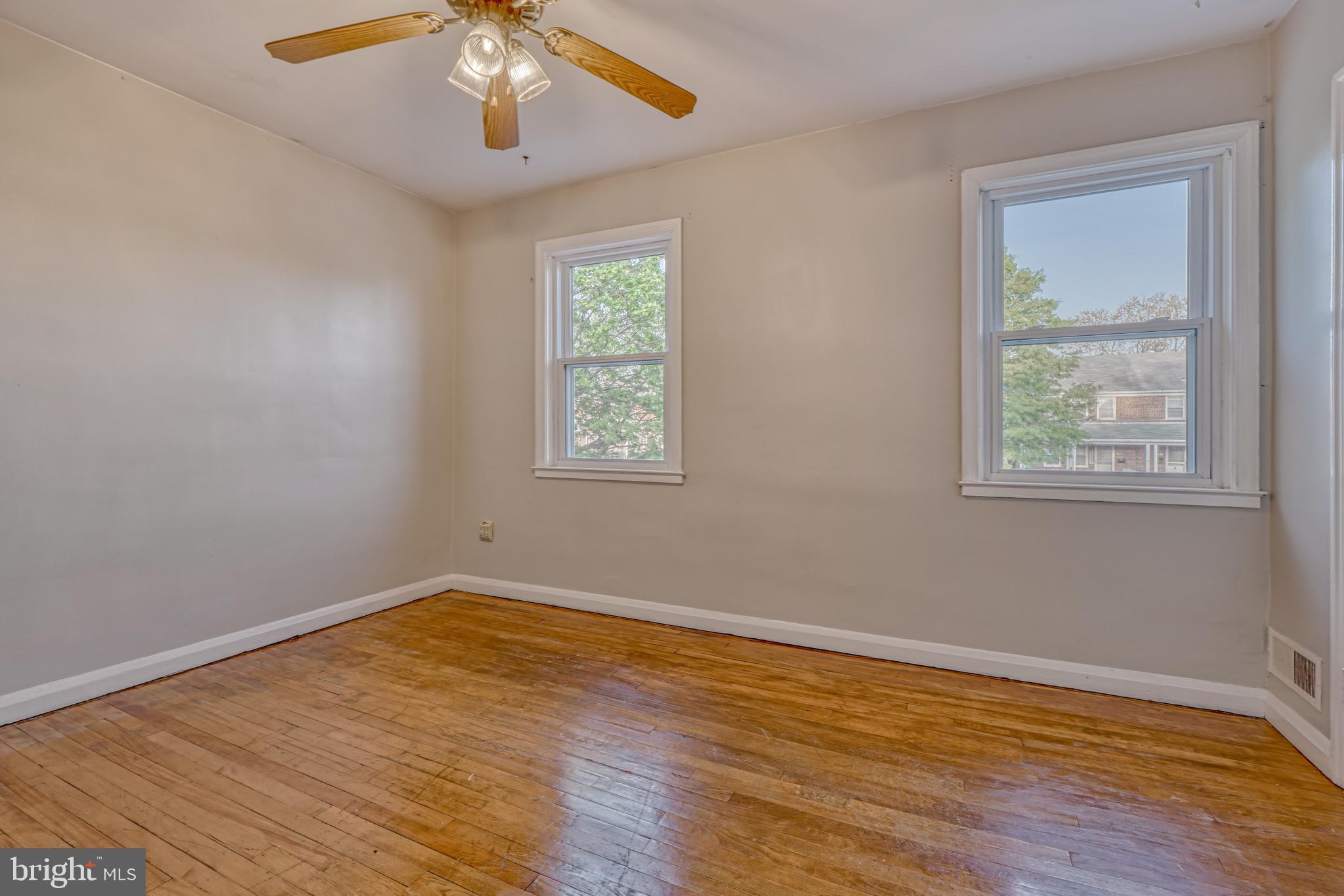 8324 Ridgely Oak Road Parkville, MD 21234 - Photo 13 of 25 a view of an empty room with wooden floor and a window