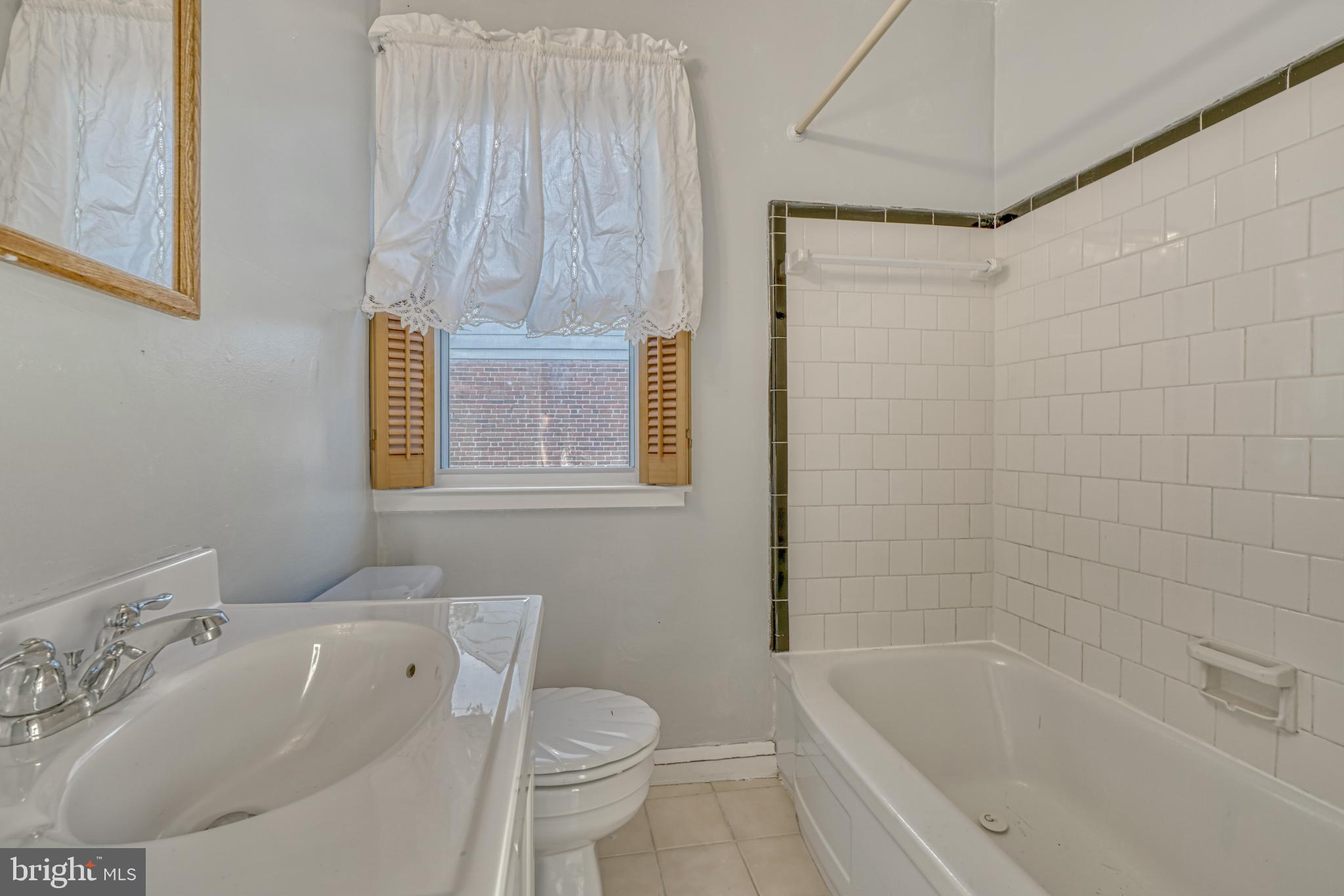8324 Ridgely Oak Road Parkville, MD 21234 - Photo 15 of 25 a bath room with a toilet sink bath tub and shower
