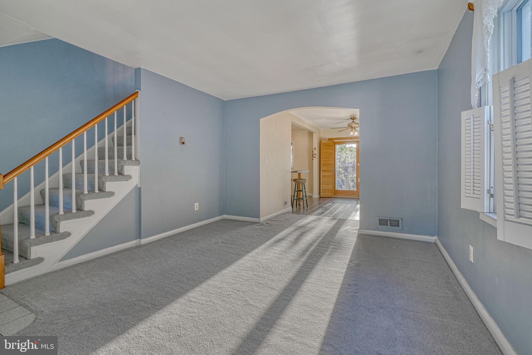 8324 Ridgely Oak Road Parkville, MD 21234 - Photo 7 of 25 a view of a hallway with wooden floor and stairs