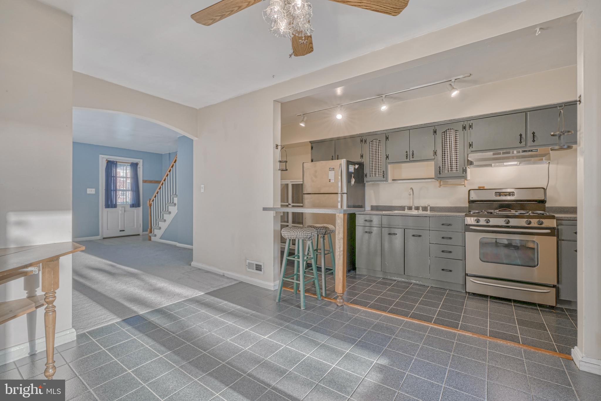8324 Ridgely Oak Road Parkville, MD 21234 - Photo 10 of 25 a kitchen with a sink stainless steel appliances and cabinets