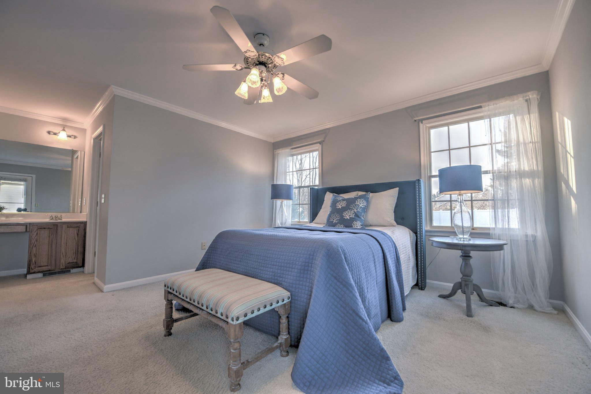 11489 Reed Circle Ridgely, MD 21660 - Photo 23 of 46 a bedroom with a bed and a chandelier
