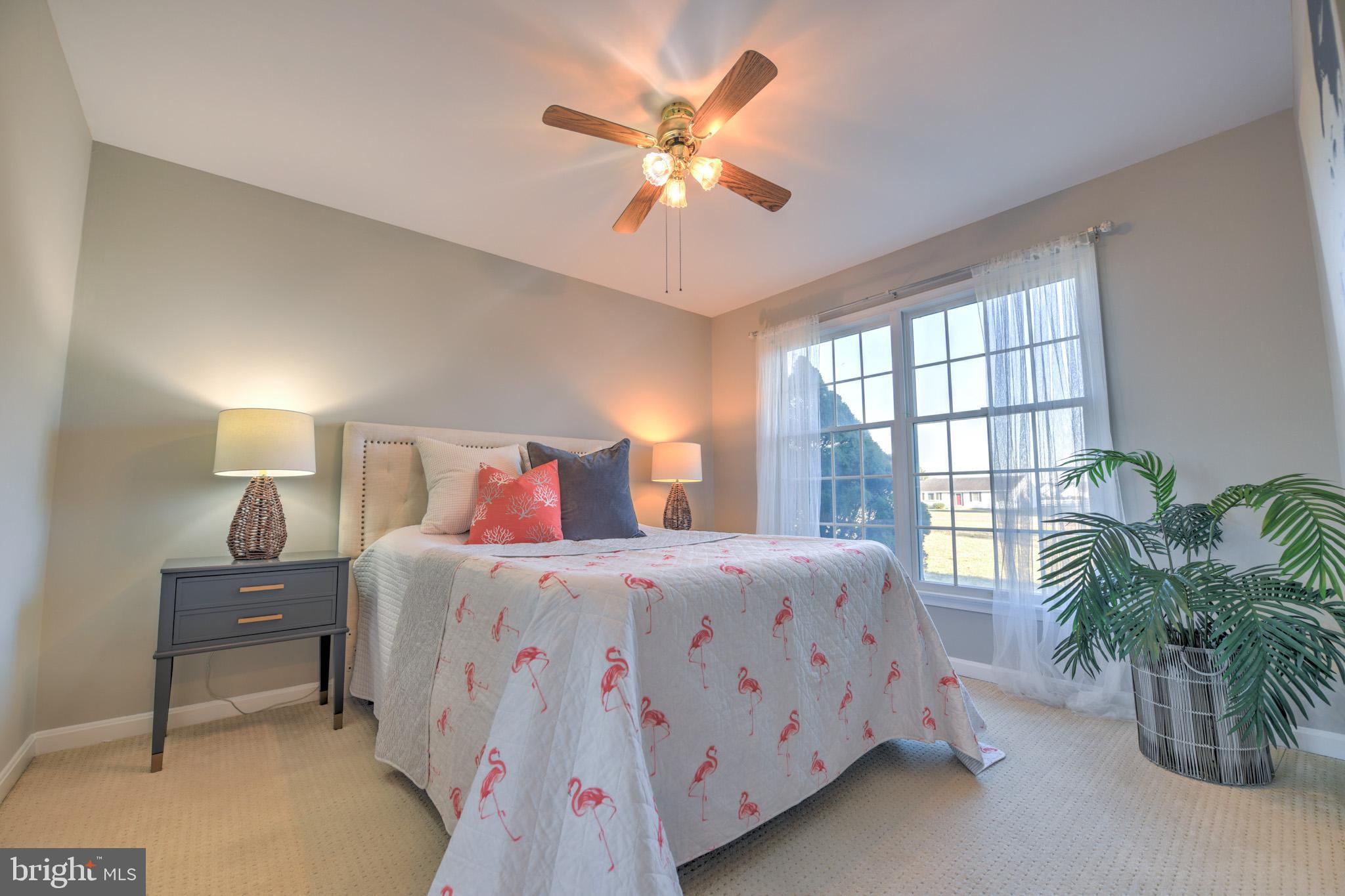 11489 Reed Circle Ridgely, MD 21660 - Photo 29 of 46 a bedroom with a bed and a chandelier