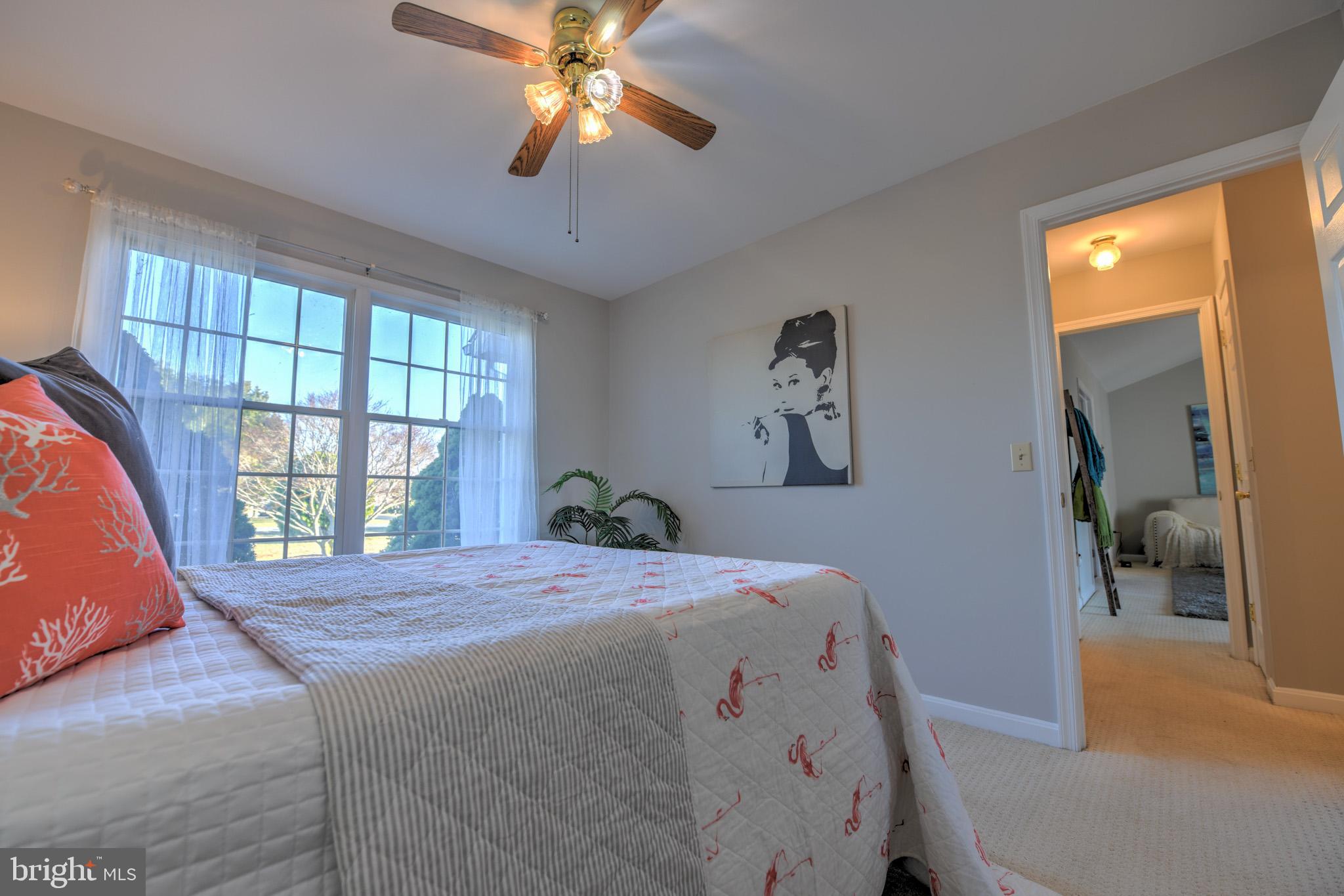 11489 Reed Circle Ridgely, MD 21660 - Photo 31 of 46 a bedroom with a bed and a chandelier
