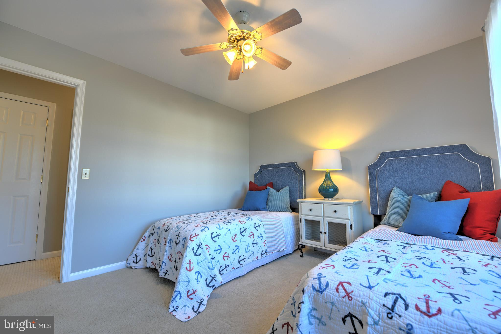 11489 Reed Circle Ridgely, MD 21660 - Photo 33 of 46 a bedroom with two beds and a chandelier