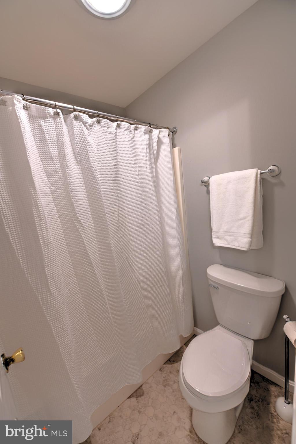 11489 Reed Circle Ridgely, MD 21660 - Photo 38 of 46 a white toilet sitting next to a shower curtain