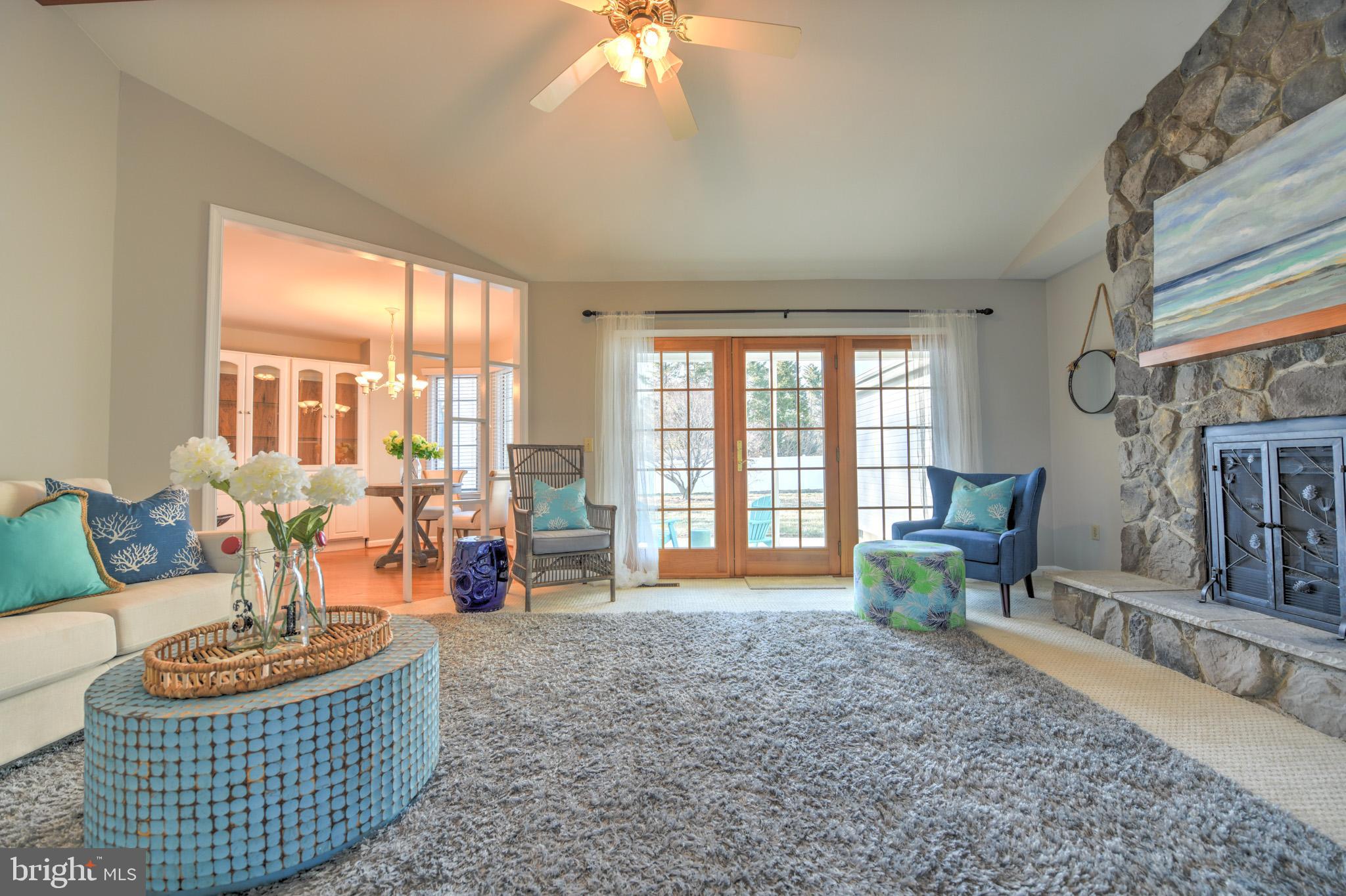 11489 Reed Circle Ridgely, MD 21660 - Photo 5 of 46 a living room with furniture a fireplace and a large window