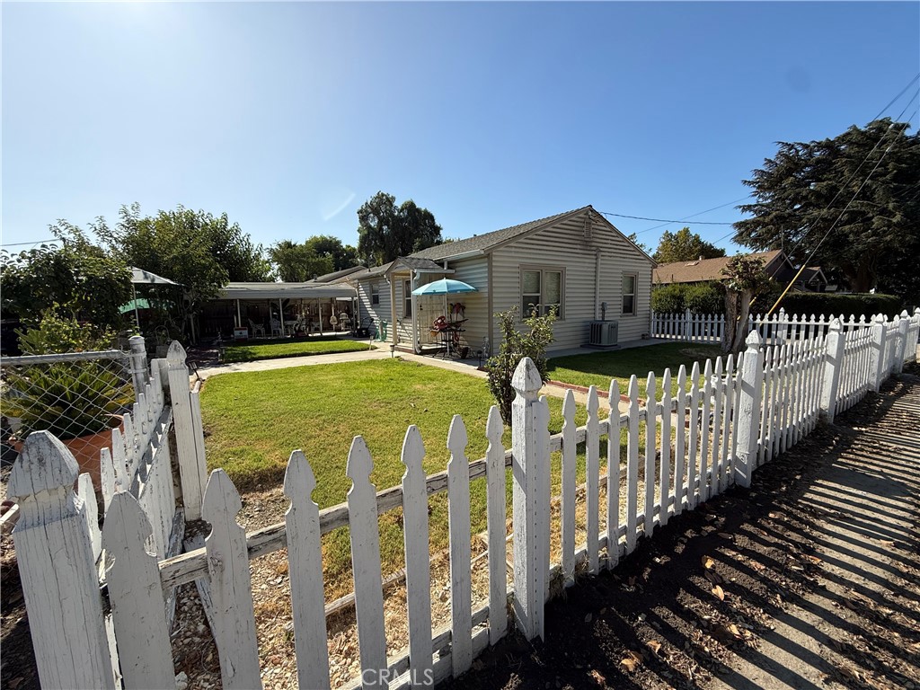 60010 Godchaux Street San Ardo, CA 93450 - Photo 2 of 4 a view of a house with wooden deck next to a yard
