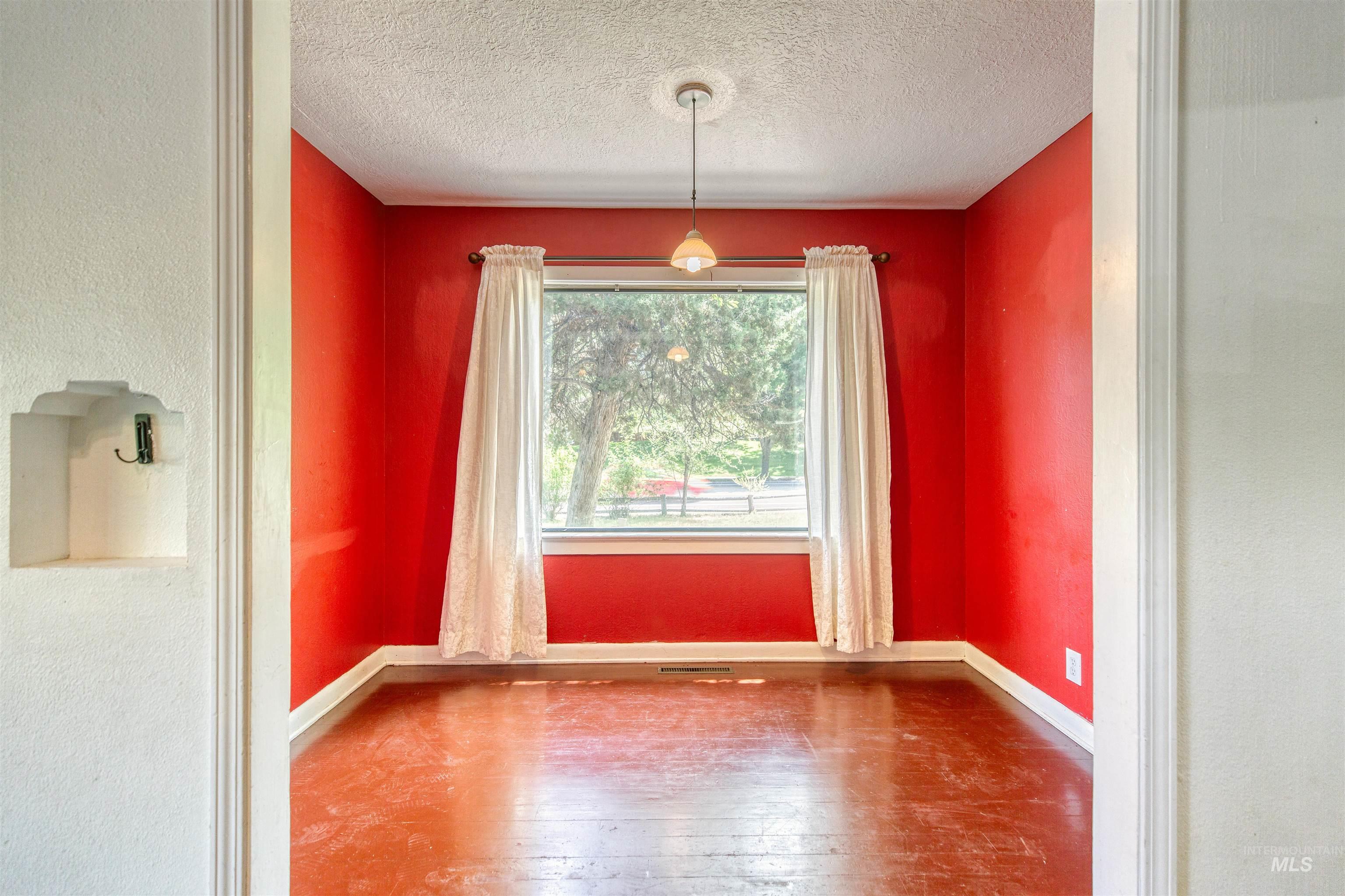 1119 North Eagle Road Eagle, ID 83616 - Photo 16 of 26 Unfurnished dining area featuring wood-type flooring, a textured ceiling, and a textured wall
