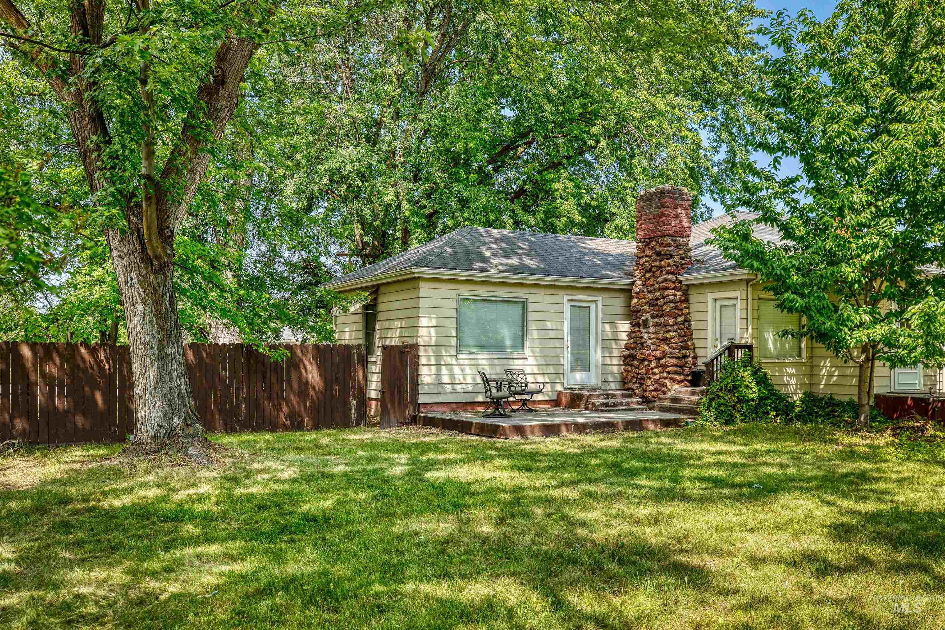 1119 North Eagle Road Eagle, ID 83616 - Photo 7 of 26 Rear view of property featuring a patio area and a chimney