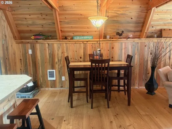 a kitchen with a table chairs and wooden floor