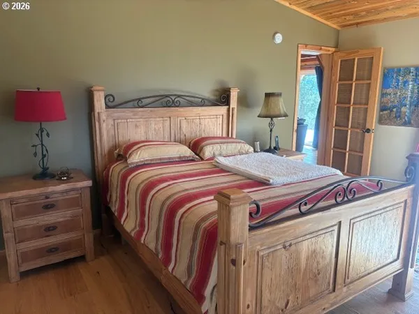 a bedroom with a bed and glass windows