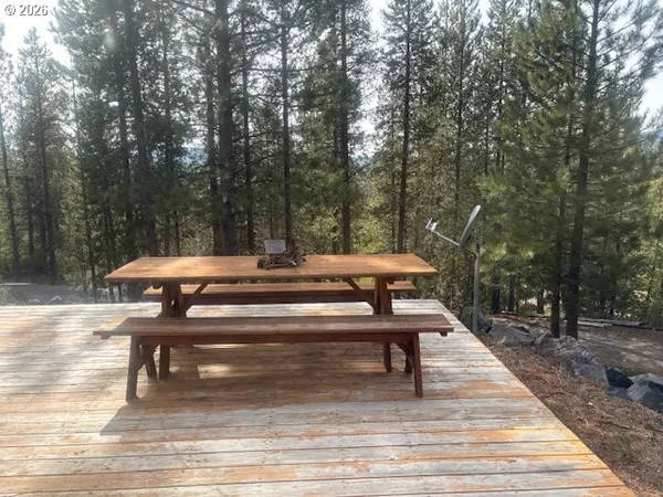 a view of backyard with swimming pool and sitting area