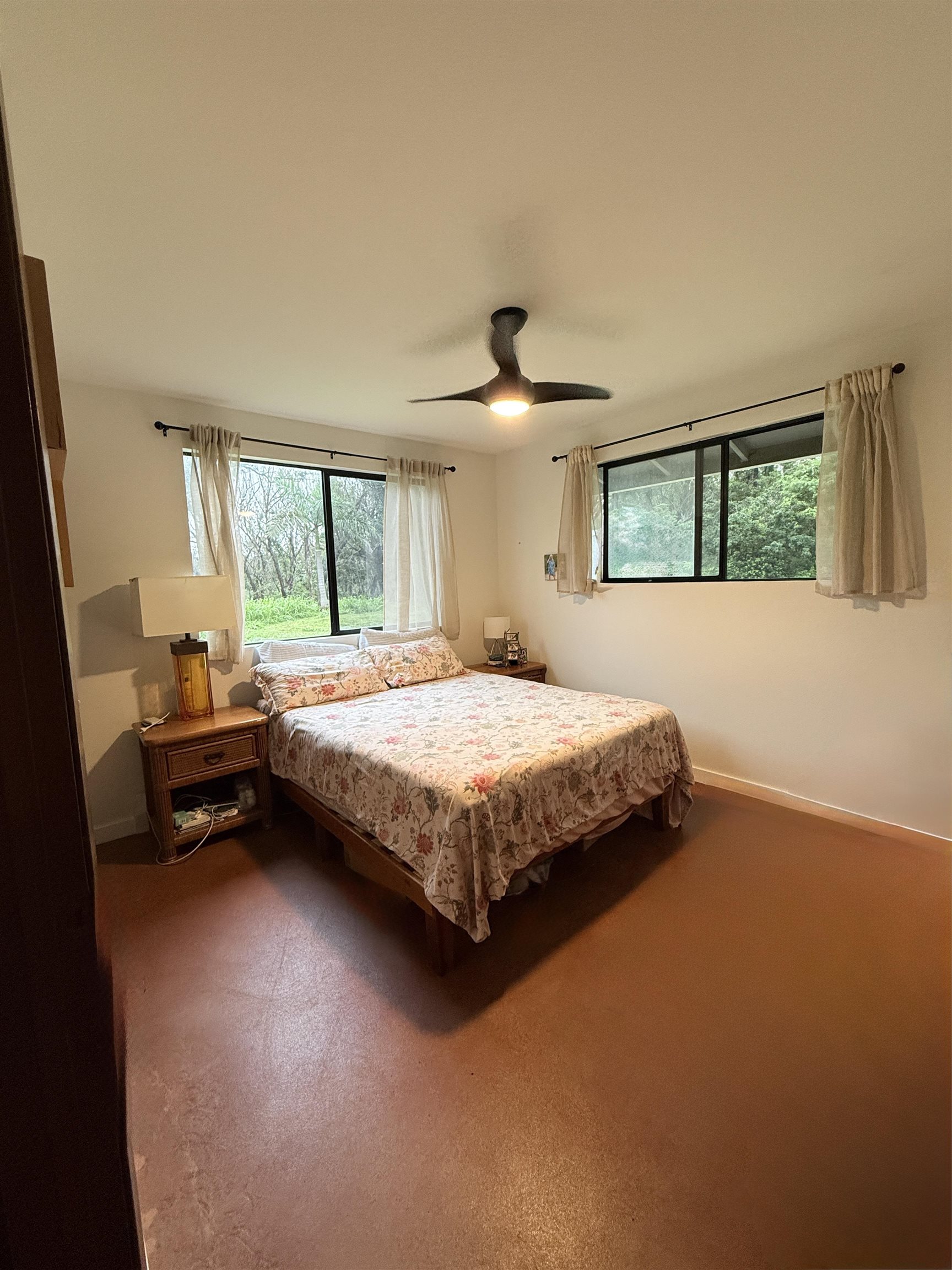 580 A Lihau Place Haiku, HI 96708 - Photo 9 of 17 a bedroom with a bed and wooden floor