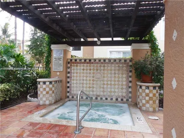 a view of a patio with table and chairs with wooden floor and fence