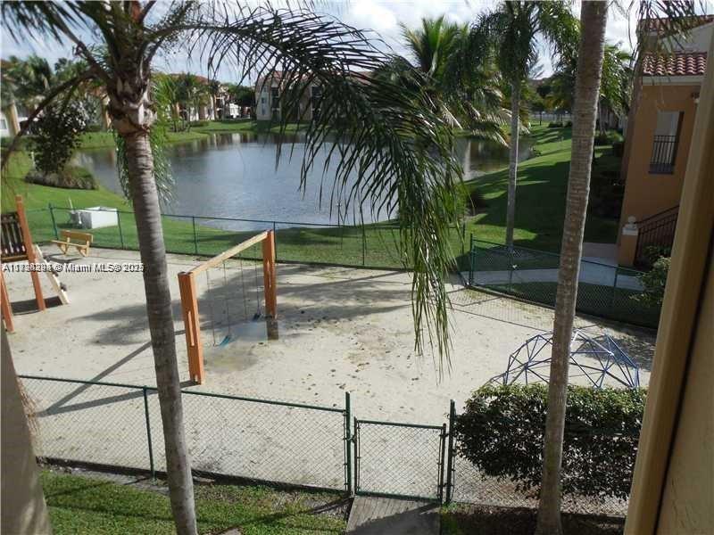 2123 Renaissance Boulevard, Unit 207 Miramar, FL 33025 - Photo 13 of 14 a view of swimming pool with a patio and a lake view