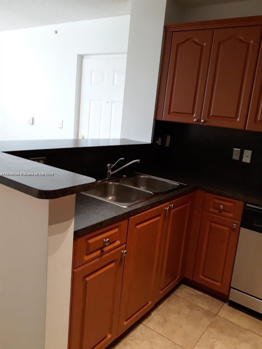 2123 Renaissance Boulevard, Unit 207 Miramar, FL 33025 - Photo 2 of 14 a kitchen with a sink and cabinets