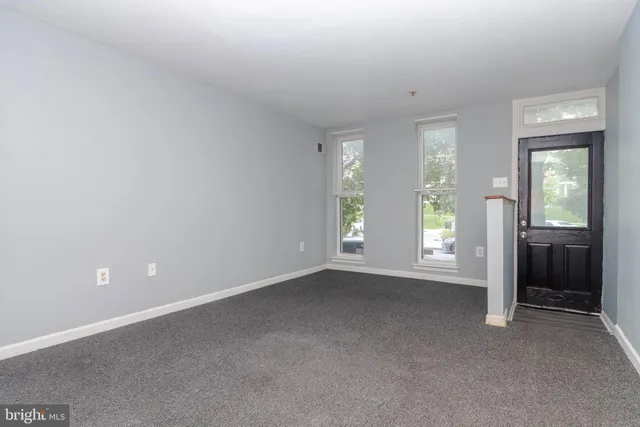 an empty room with windows and closet