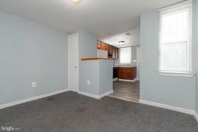 an empty room with furniture and a window