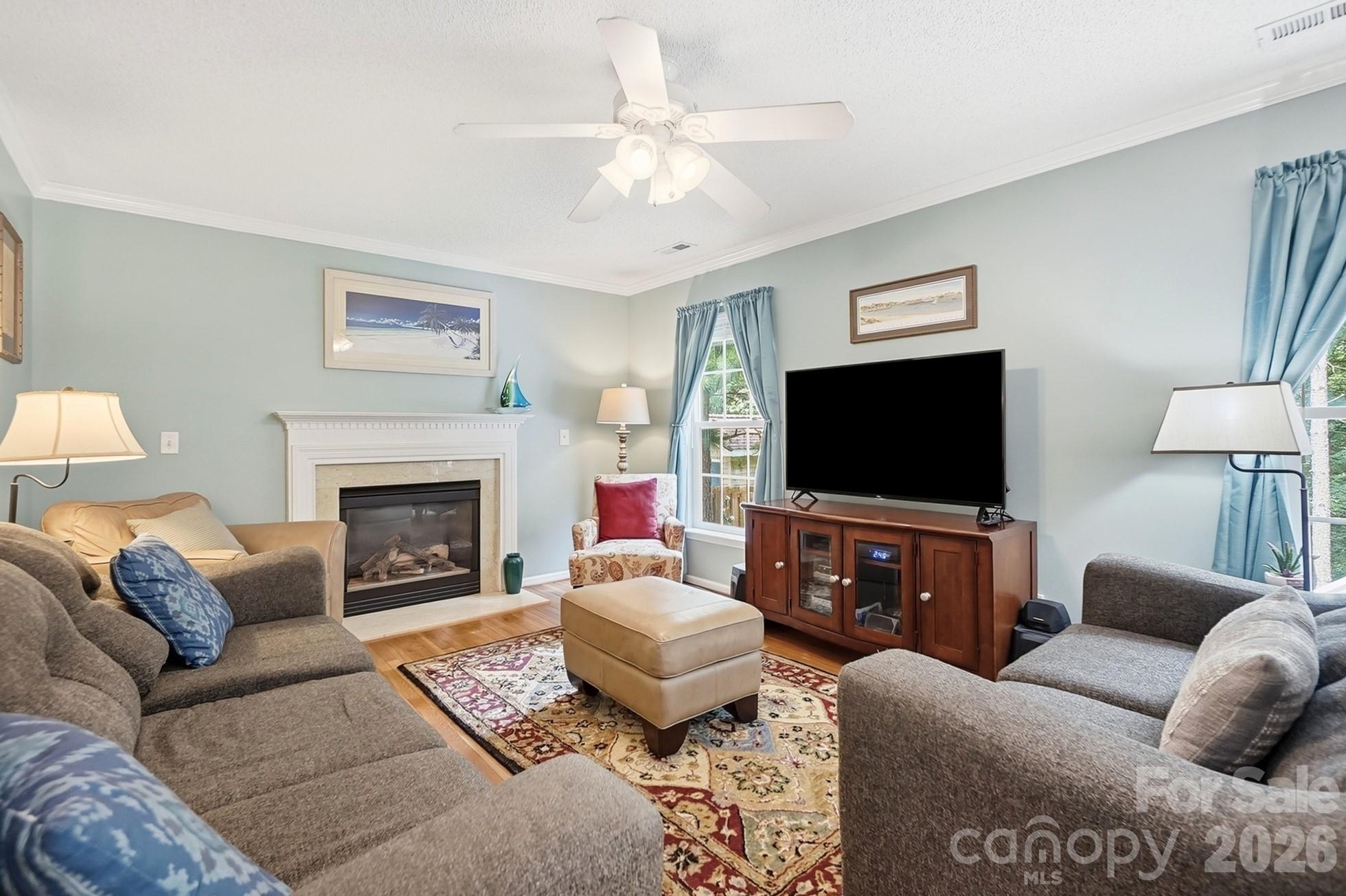 442 Sugar Maple Drive Tega Cay, SC 29708 - Photo 4 of 48 a living room with furniture a flat screen tv and a fireplace