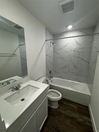 a bathroom with a sink toilet bathtub and shower