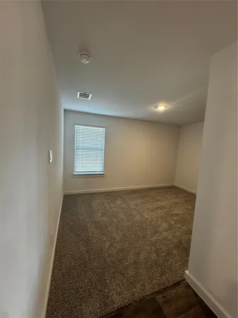 an empty room with a empty space and window