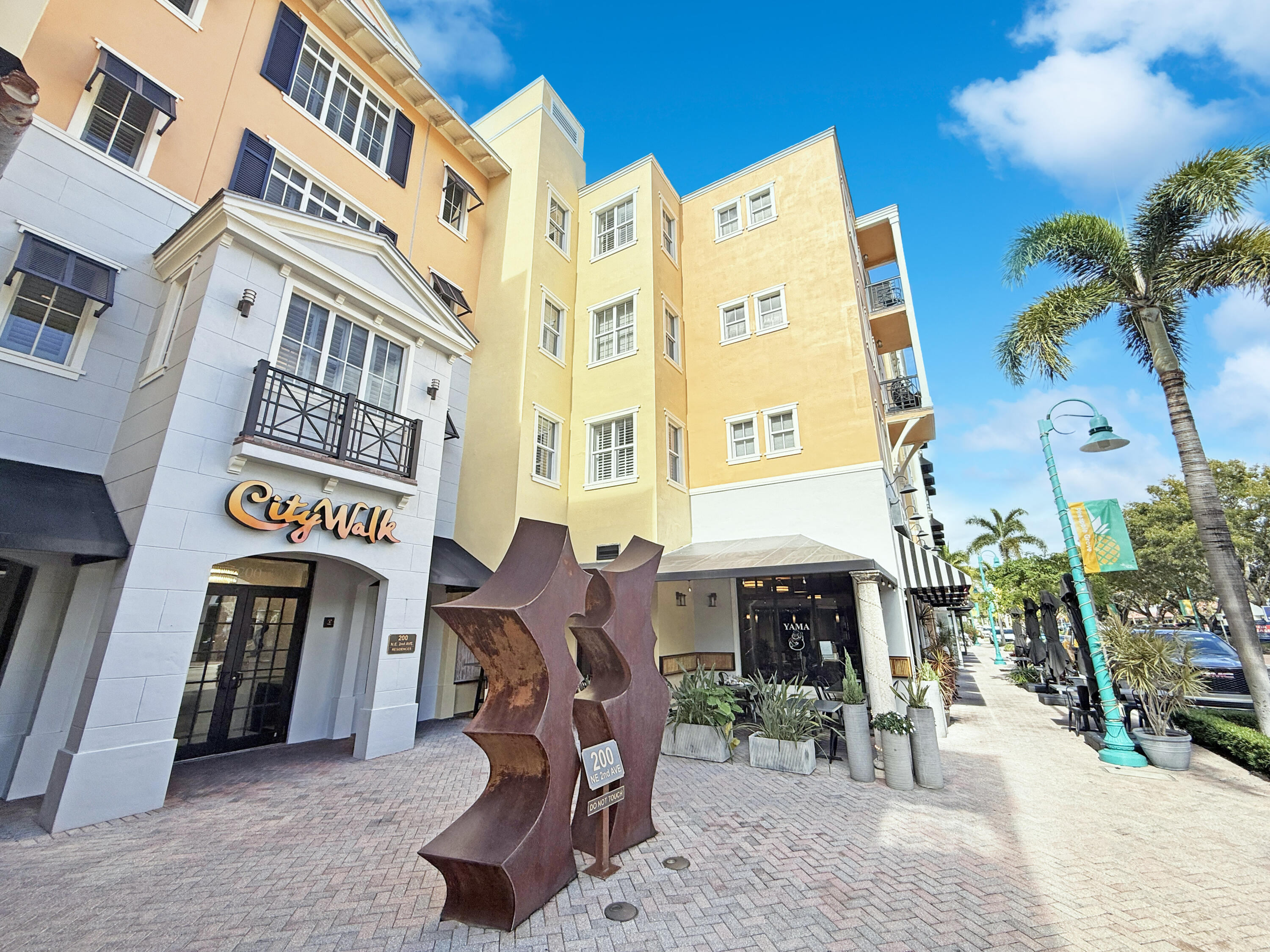 a front view of a building with outdoor seating