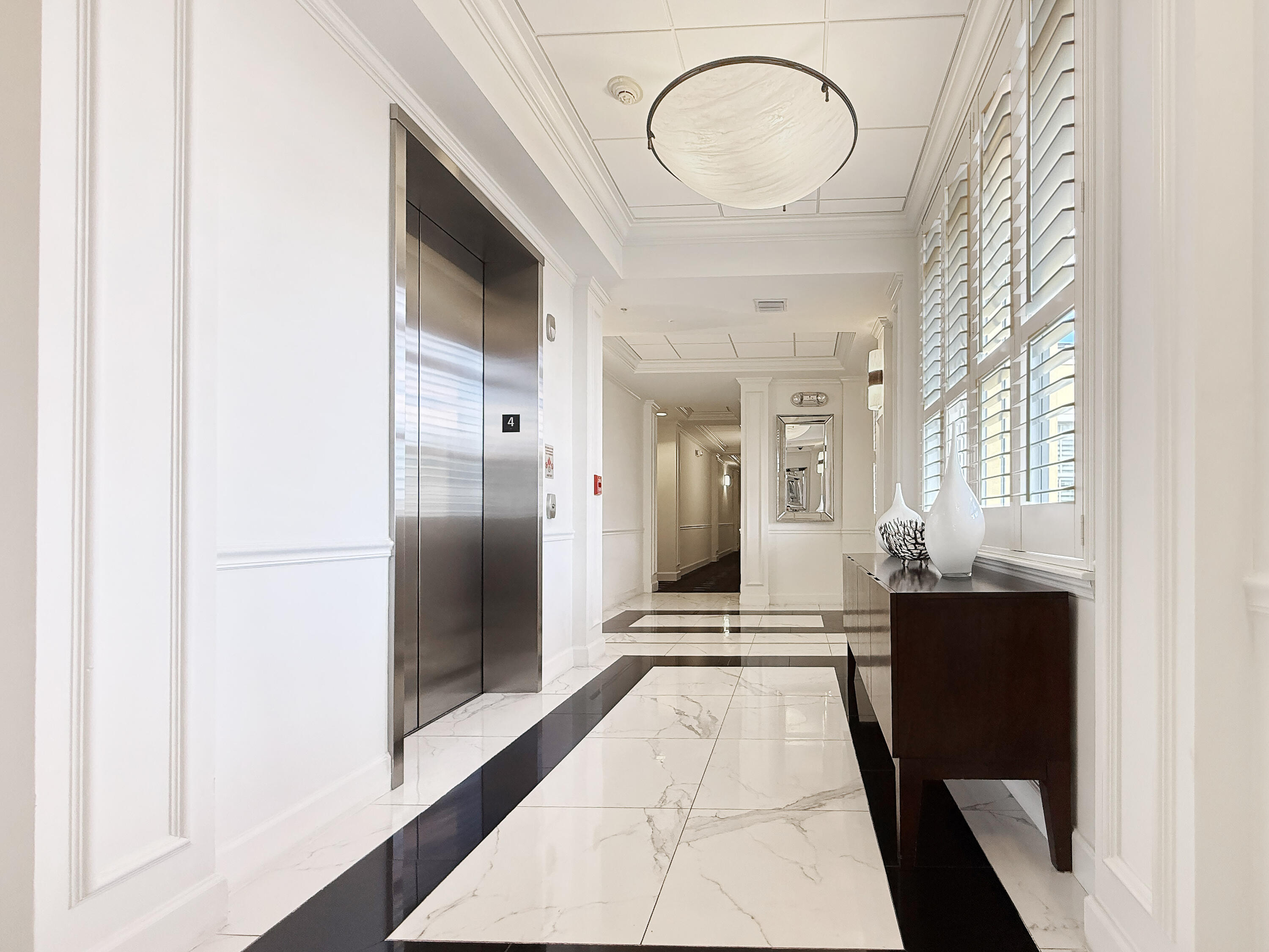 200 Northeast 2nd Avenue, Unit 414 Delray Beach, FL 33444 - Photo 11 of 16 a view of a hallway with wooden floor and a bathroom